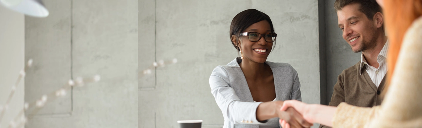 Black woman shaking an interviewees hand