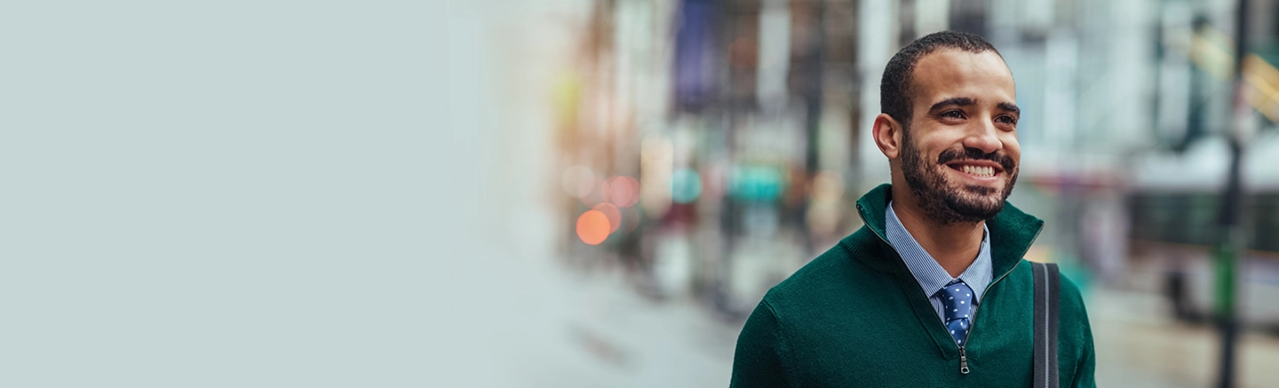 Man wearing suit and smiling walking on street