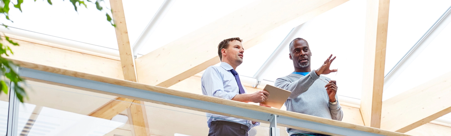 Men with tablet device on balcony