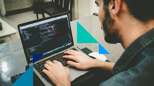 A man coding in his laptop.