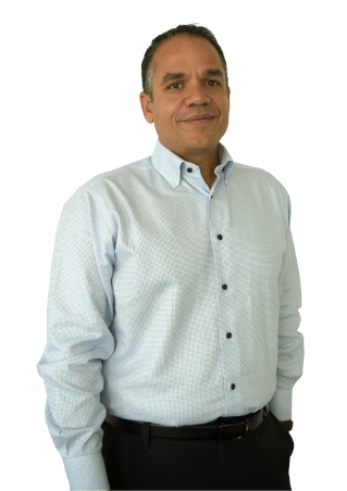 An image of Dave Brown, Chief Executive Officer Hays Americas, in a white button down shirt and black pants and belt. He has one of his hands inside his pocket.