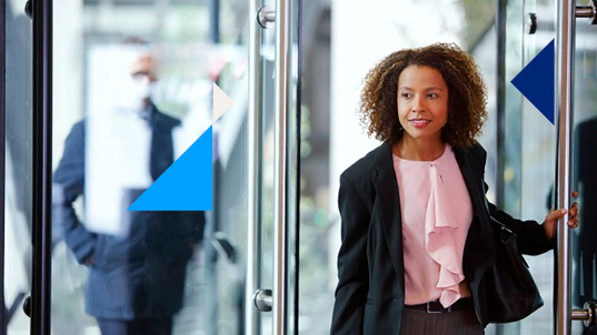 Woman walking through a glass door