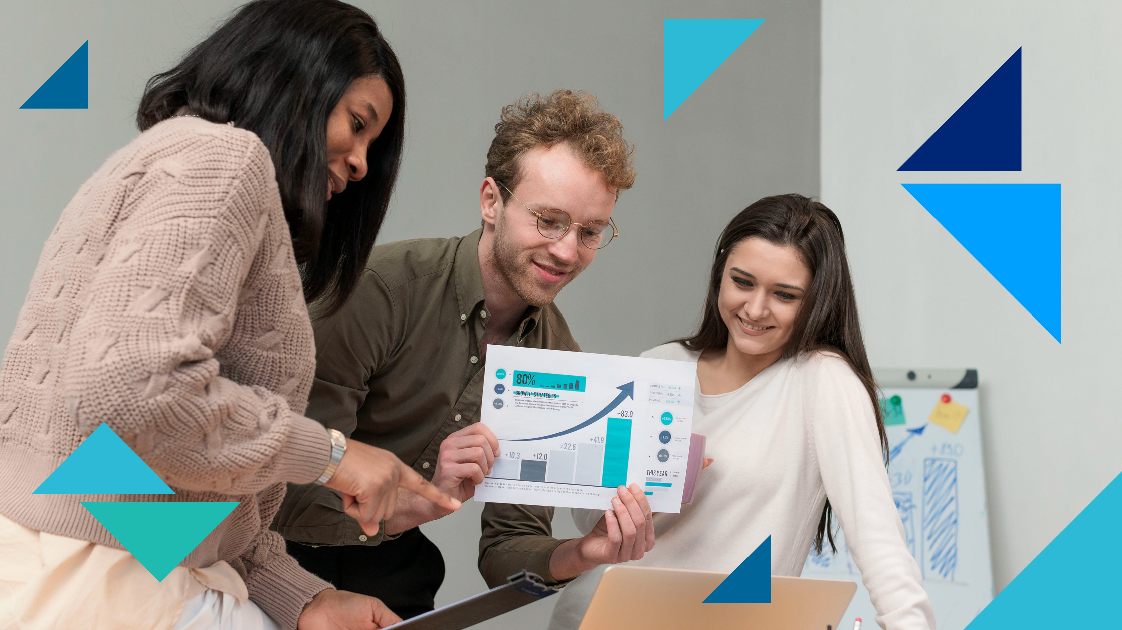 Two women and a man show a page of analytics with a chart and an arrow pointing upwards.